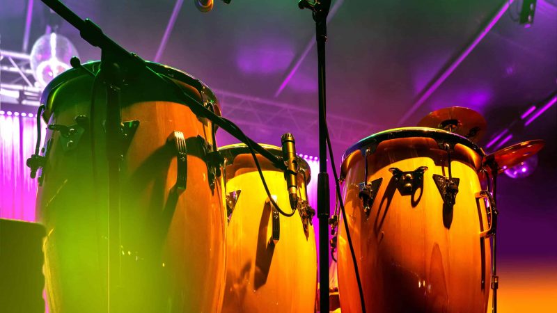 Conga drum instrument with colored background Afro-Latino Week Cazateatro Bilingual Theatre Group